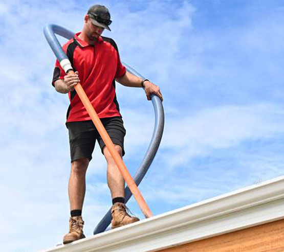 gutter-cleaner-cleaning-house-gutters-crop gutter cleaner cleaning house gutters